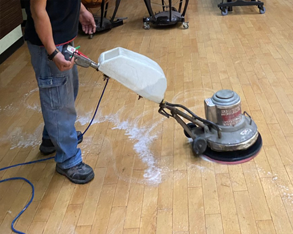 worker-waxing-wooden-floor